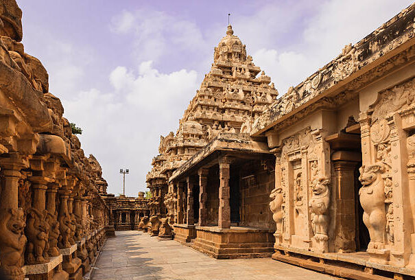 Built on the banks of the Vedavathi River, the 1300 year old Kailasanathar Temple is the oldest structure in in the Tamil Nadu city of Kanchipuram in South India. Built by the Pallava King Rajasimha also known as Narasimhavarman II, in the Dravidian style of architecture, Carved and sculpted almost completely out of sandstone, it was built between 685 and 705 AD; it is dedicated to the god Shiva. Photo shot in the afternoon sunlight shows the circumambulatory passage of the western side; on the left is the inner side of the outer wall as well. Each of the sections houses a shrine - 58 in total. Converging lines make for an interesting photograph. Horizontal format; no people. Copy Space.